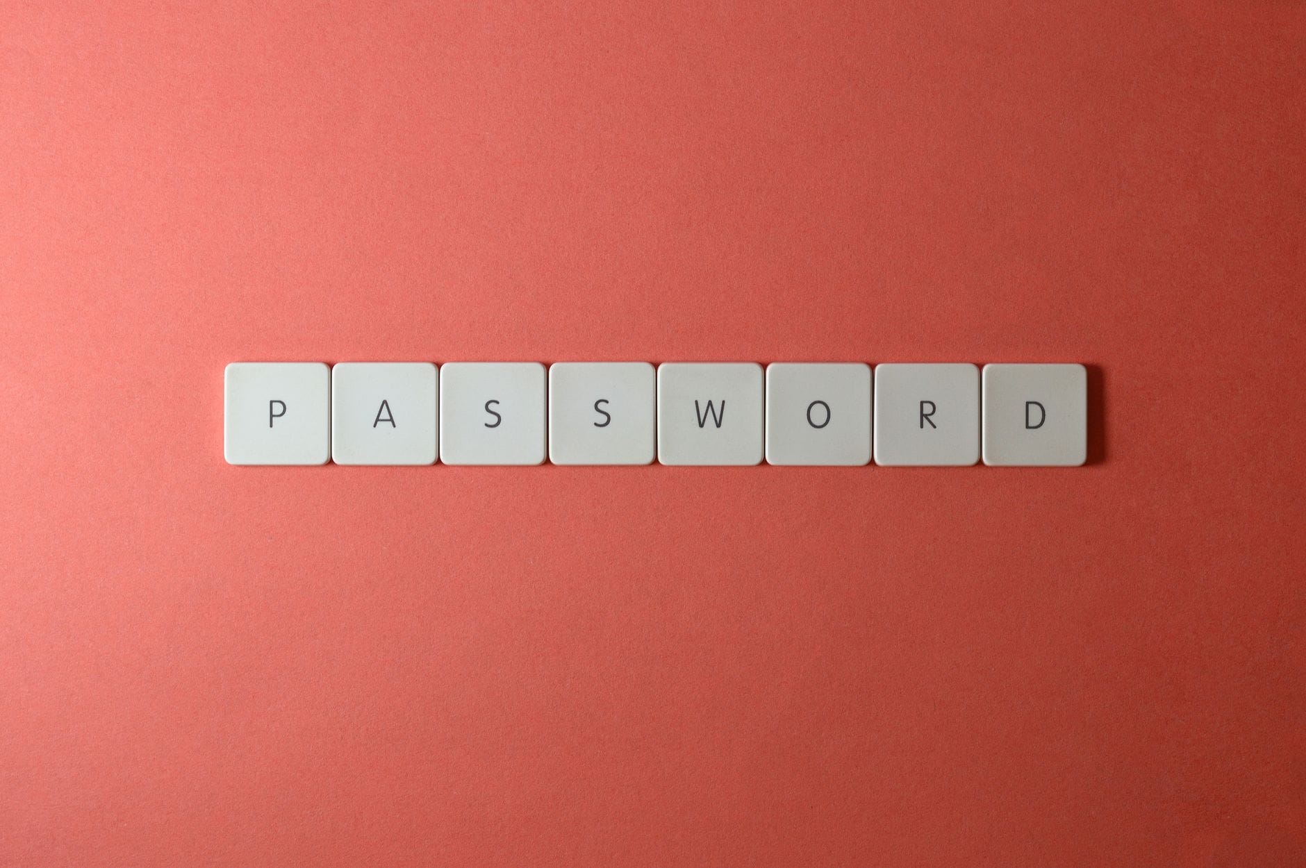 Białe klawisze z napisem PASSWORD na koralowym tle Białe klawisze z napisem PASSWORD na koralowym tle